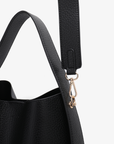 Close-up of a Paloma black handbag with a strap and clasp.