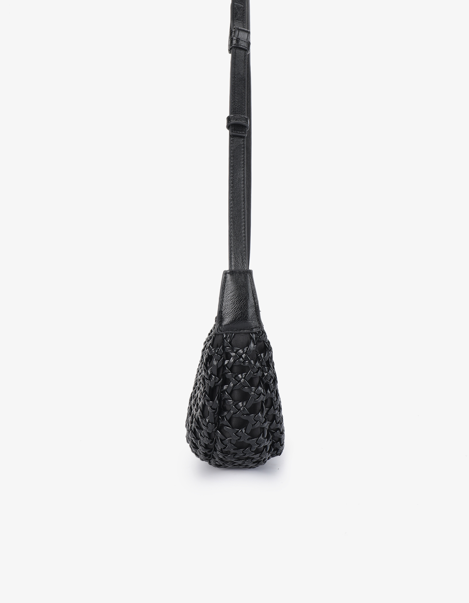 Slim side profile of a black woven crossbody bag showing its tapered shape and thin adjustable strap by Remi and Reid.