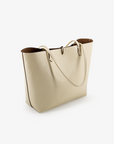 Reversible cream and taupe colored tote bag with a sleek design and a removable security pouch.
