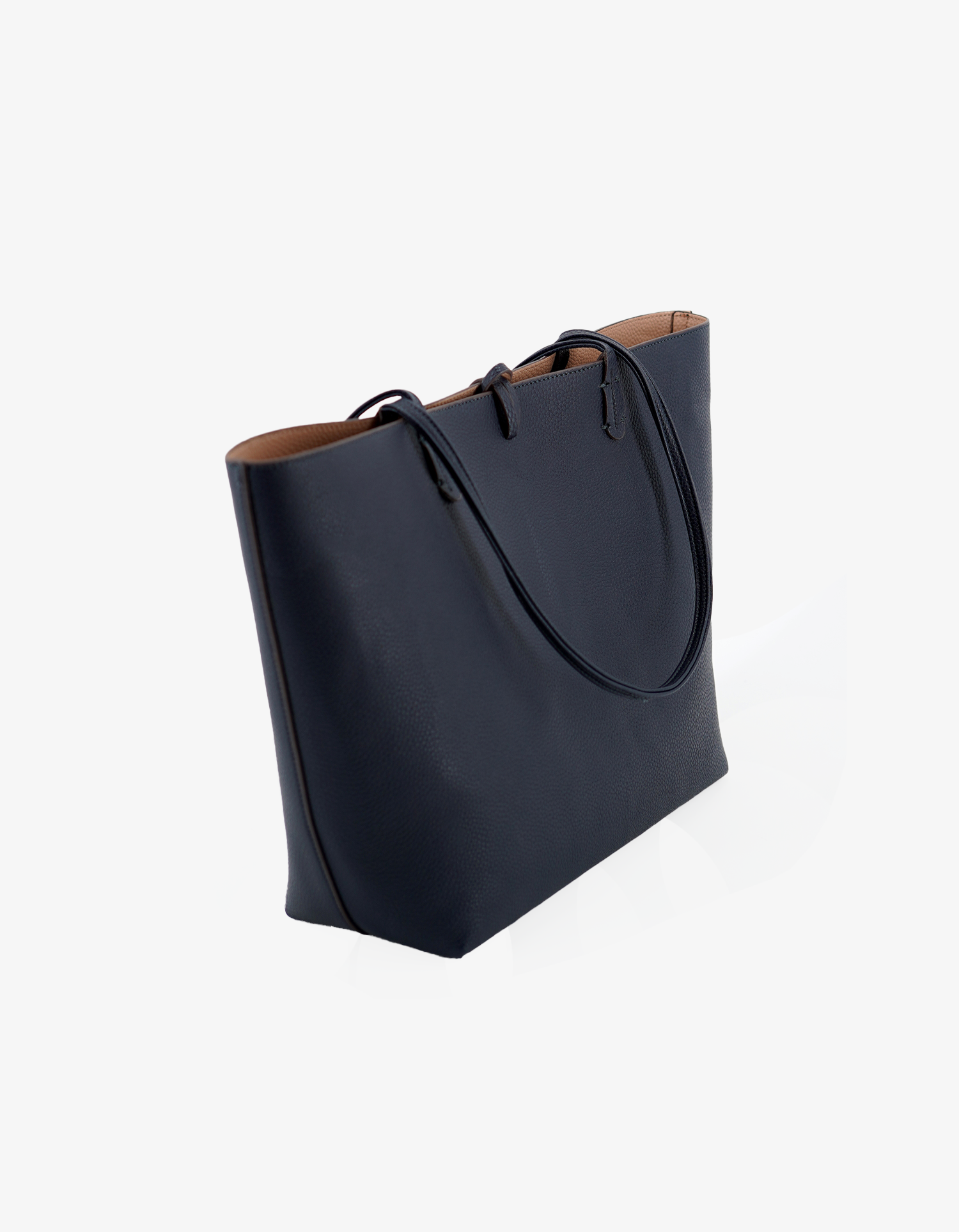 Front angled reversible navy and nude colorway vegan leather tote bag by Remi and Reid