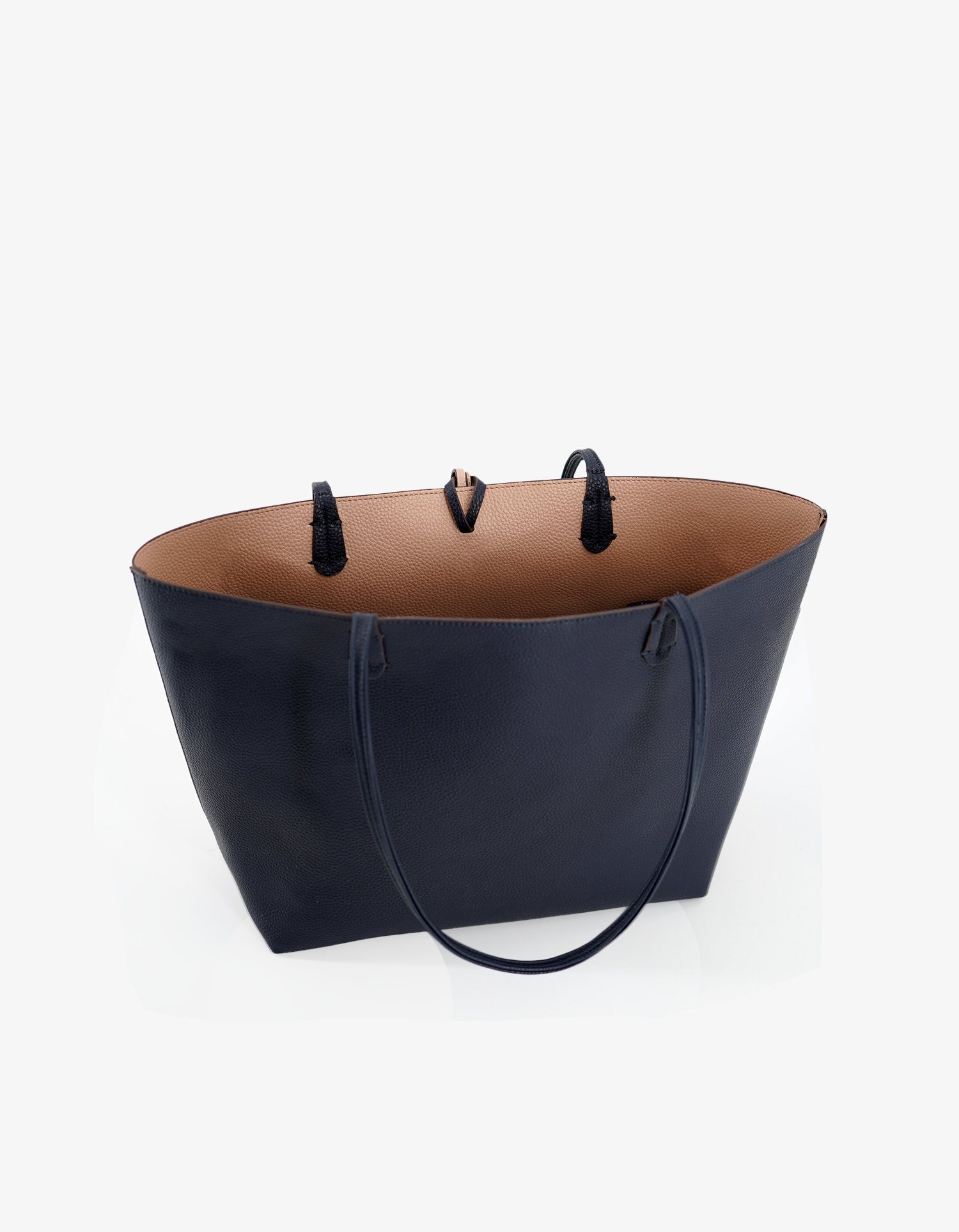 Spacious interior of reversible Departure vegan leather tote bag in navy blue and nude colorway by Remi and Reid