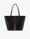Black and navy blue reversible Departure tote handbag with a navy and red stripe on the front, featuring a removable security pouch with a crossbody strap by Remi and Reid