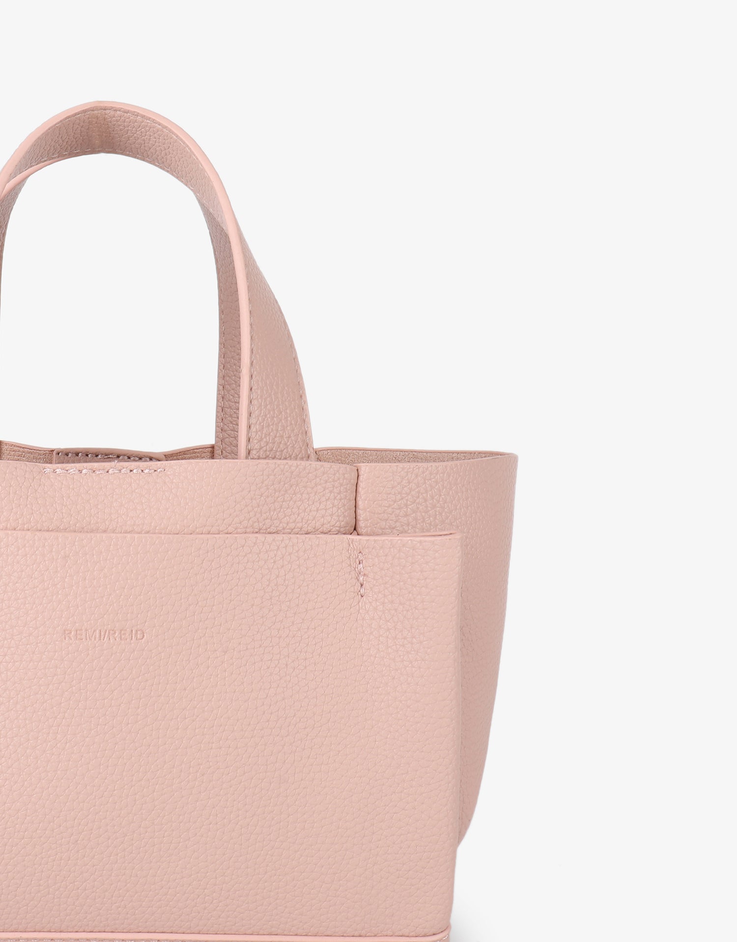 Close-up of pink mini tote bag with front pocket details_Remi and Reid