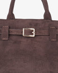 Close-up of brown faux suede mini doctor bag with a belted strap_Remi and Reid