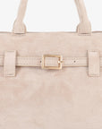 Close-up of beige faux suede mini doctor bag with a belted strap_Remi and Reid