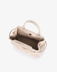 Luxurious interior of beige faux suede handbag with magnetic snap closure_Remi and Reid