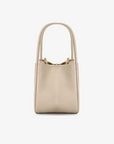 A cream-colored mini tote handbag with two handles by Remi and Reid.
