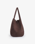 Side profile of a brown mini handbag with studded details_Remi and Reid