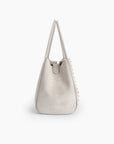 Cream white mini bucket bag with studded details in side view_Remi and Reid
