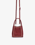 Wine red handbag with studded design and body strap_Remi and Reid