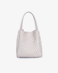 A cream-colored mini tote bag with a woven design, featuring two handles and a detachable crossbody strap.