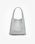 A shiny silver mini tote bag with a woven design, featuring two handles and a detachable crossbody strap by Remi and Reid.