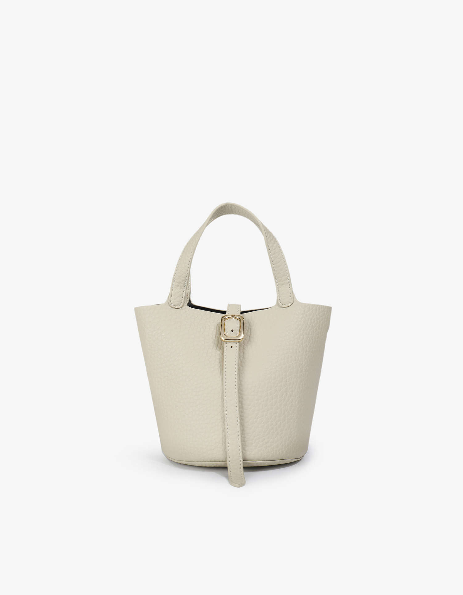 Joya cream-colored vegan leather bucket bag with a shoulder strap and a front buckle detail, by Remi and Reid