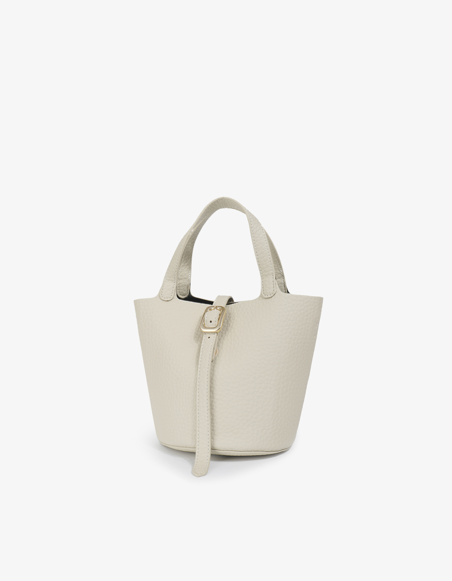 Cream Joya Bucket Mini in pebbled vegan leather with a gold buckle detail and short top handles by Remi and Reid.