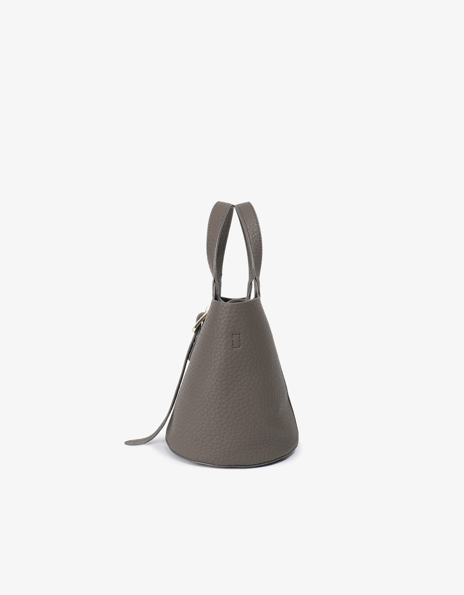 Side detail of Joya vegan leather mini bucket bag in dark grey with a buckle closure on the front and a long strap design by Remi and Reid.