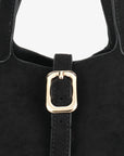 Close-up of a black bucket bag with gold buckle design_Remi and Reid