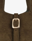 Close-up of a brown suede handbag with a gold buckle_Remi and Reid