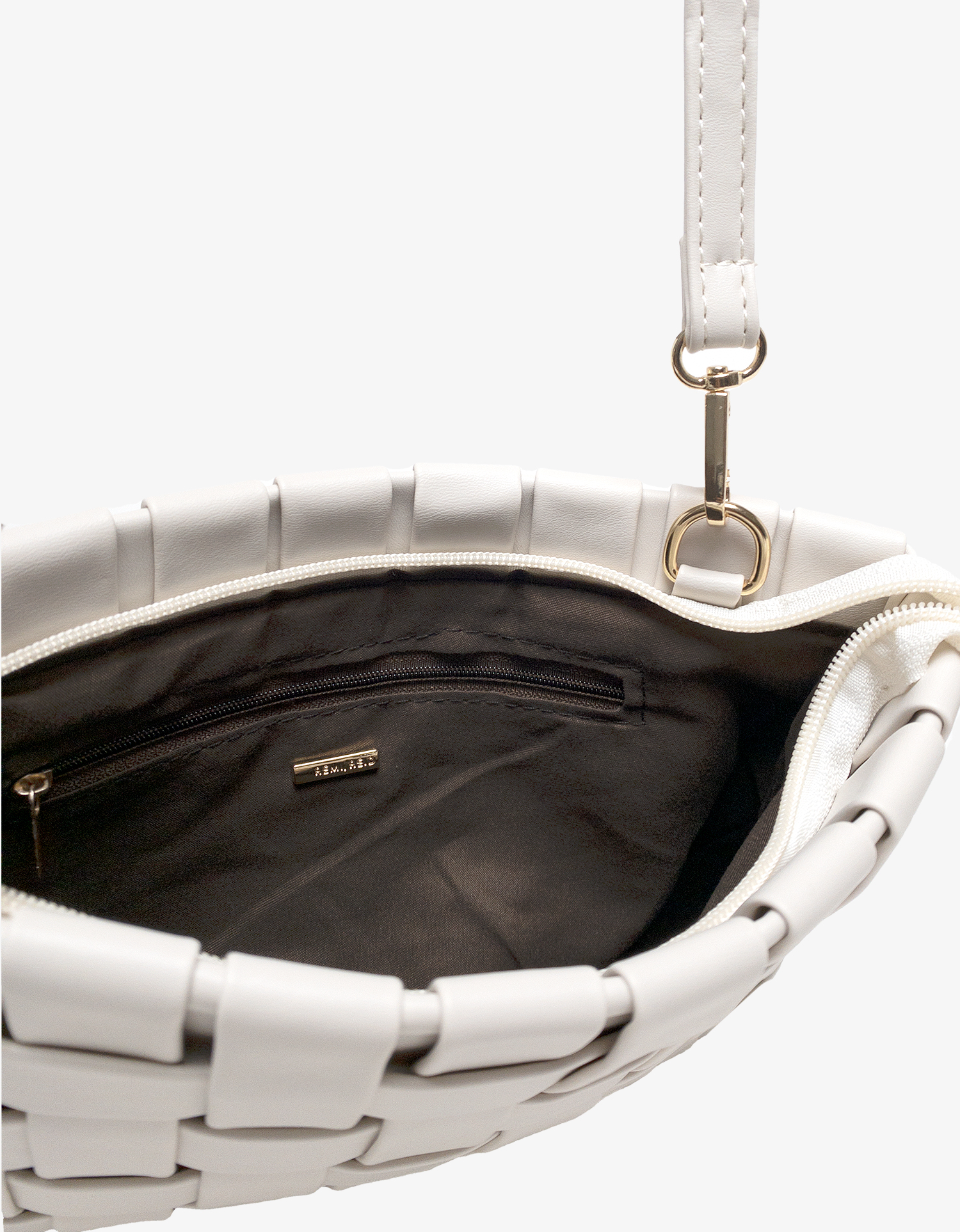 Close-up of white woven handbag with a zipper by Remi and Reid.