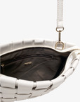 Close-up of white woven handbag with a zipper by Remi and Reid.