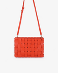 Orange woven handbag with adjustable crossbody and shoulder strap by Remi and Reid.