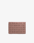 A rose-colored, large woven clutch with a structured exterior by Remi and Reid.