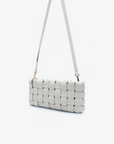 Small white woven clutch bag with detachable, adjustable crossbody strap by Remi and Reid.