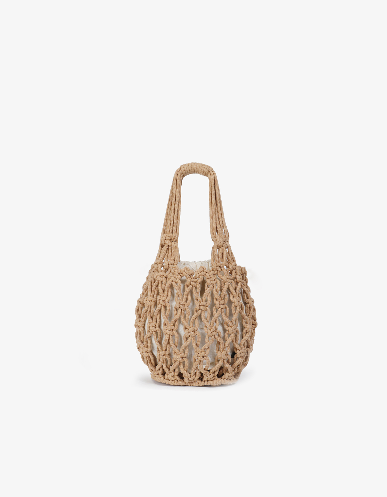Miel knotted bucket tote bag in light tan with open weave macrame pattern design and inner drawstring pouch by Remi and Reid.