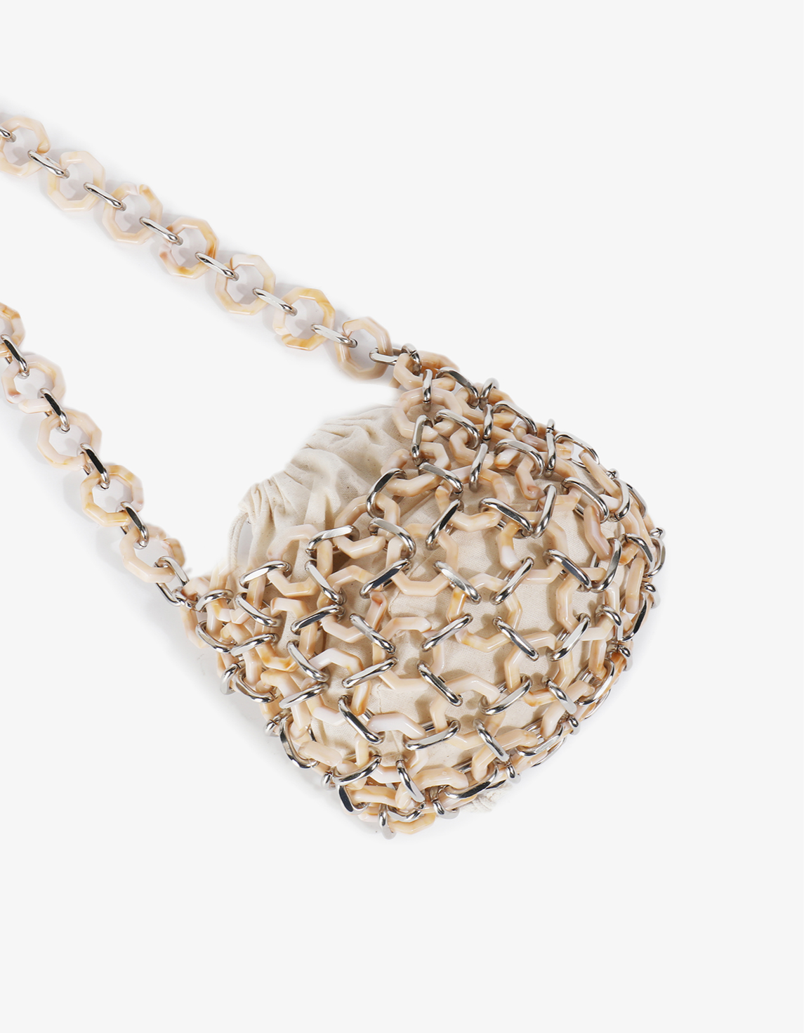 Pink Nadia Shell bag highlighting a chainmail-style acrylic cage and a tonal fabric inner lining by Remi and Reid.