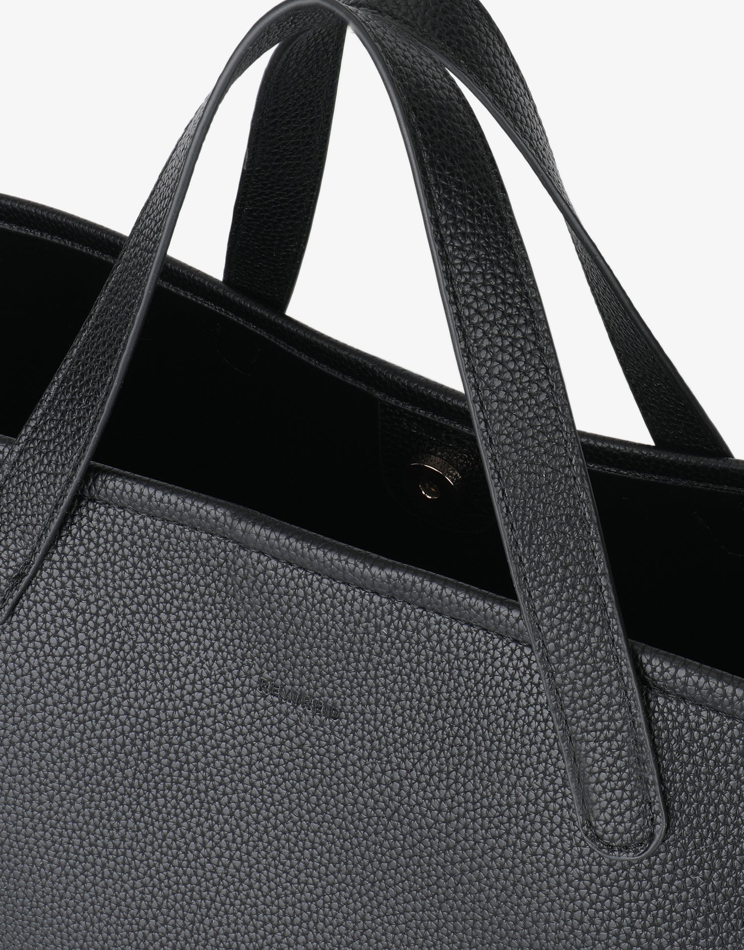 Close-up of Nala tote east west black vegan leather handbag with magnetic snap closure by Remi and Reid