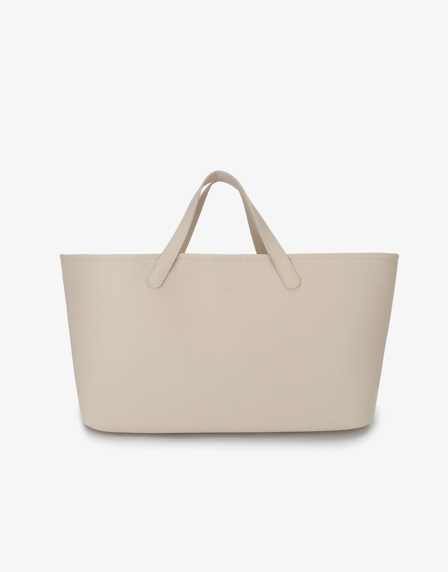 Cream-colored East West Nala Tote by Remi and Reid featuring a horizontal shape and short shoulder handles.