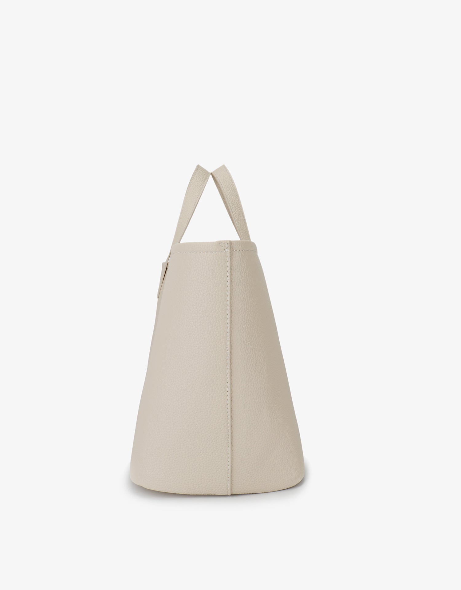 Side view of cream-colored East West Nala Tote by Remi and Reid featuring a horizontal shape and short shoulder handles.