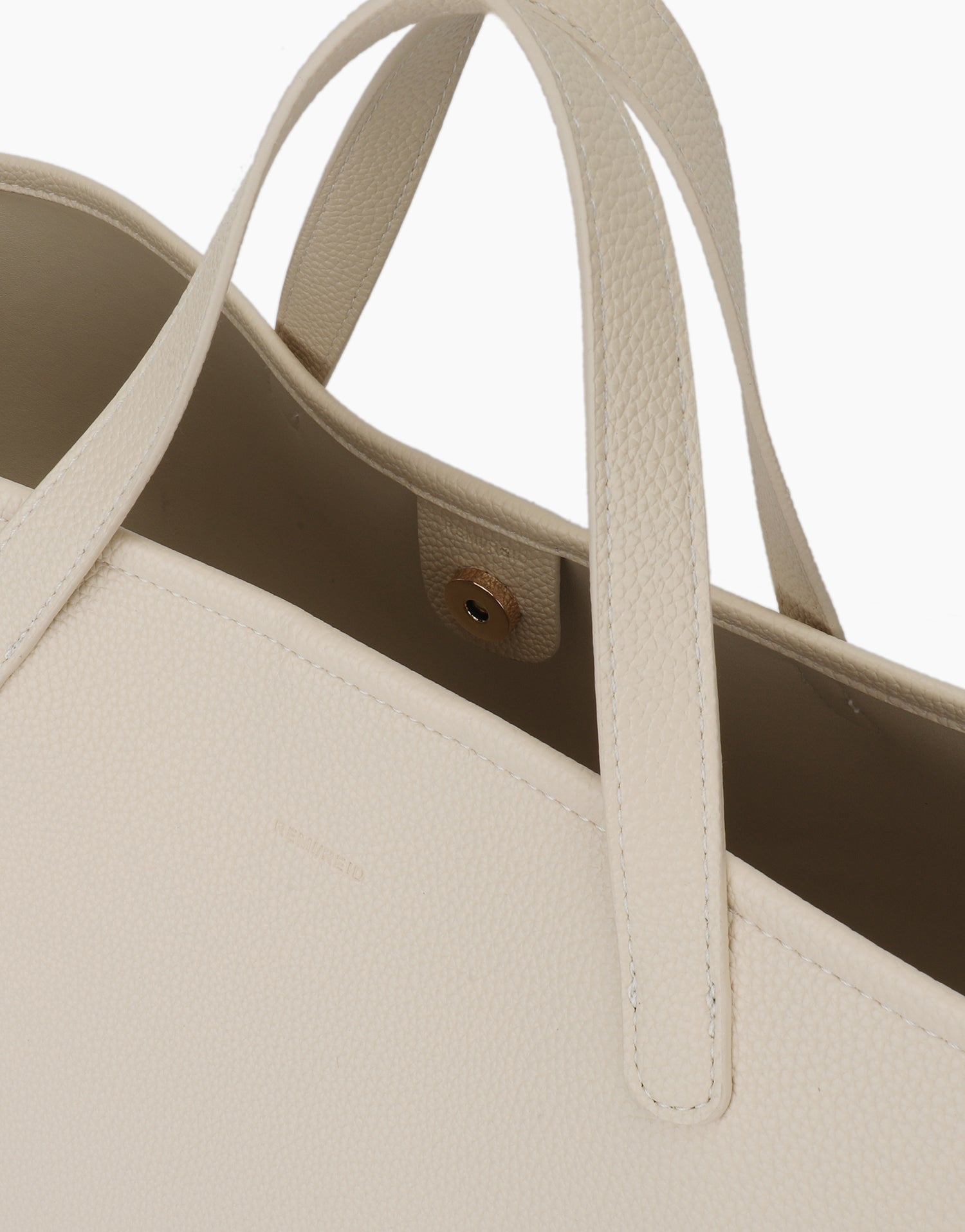 Close-up of Nala East West tote with magnetic snap closure by Remi and Reid.
