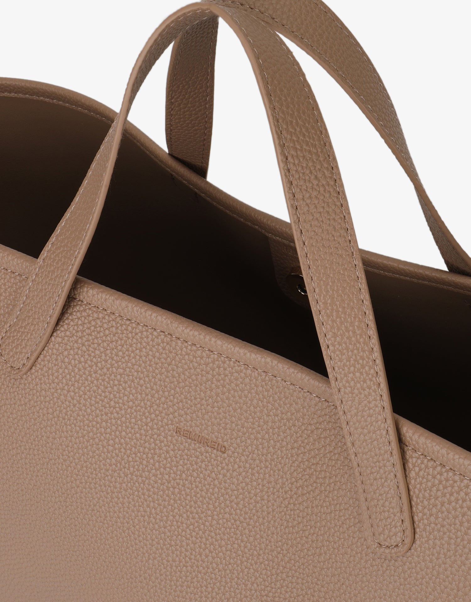 Close-up of Nala Tote East West featuring the snap closure and stitching by Remi and Reid