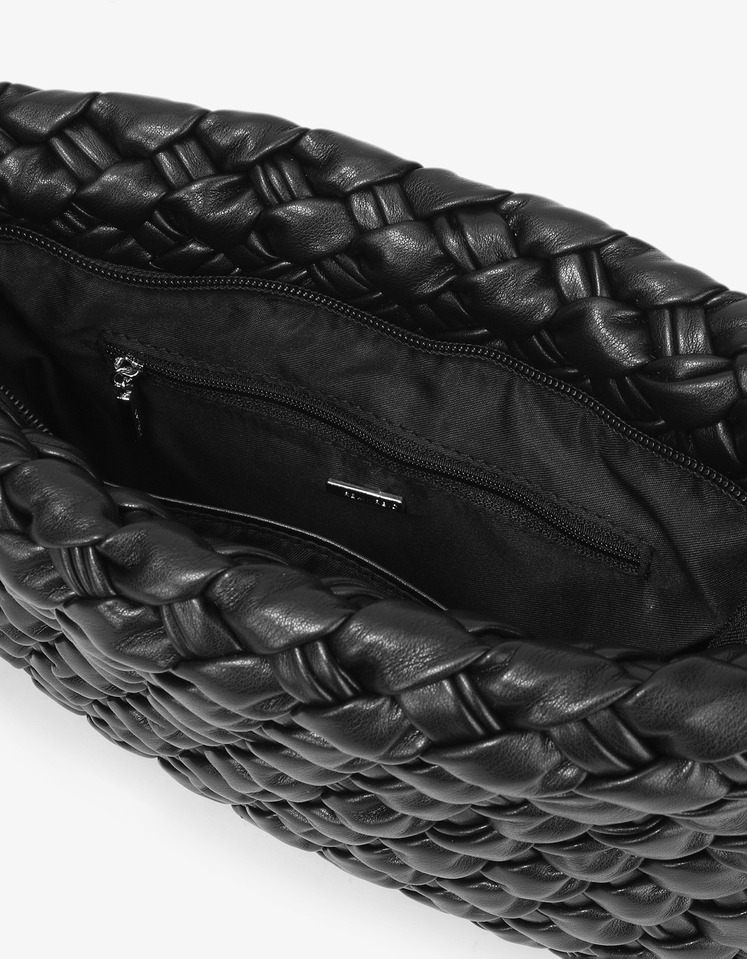 Close-up of Nieves 3D woven edges and lined interior clutch with zippered and slip pockets in black by Remi and Reid.