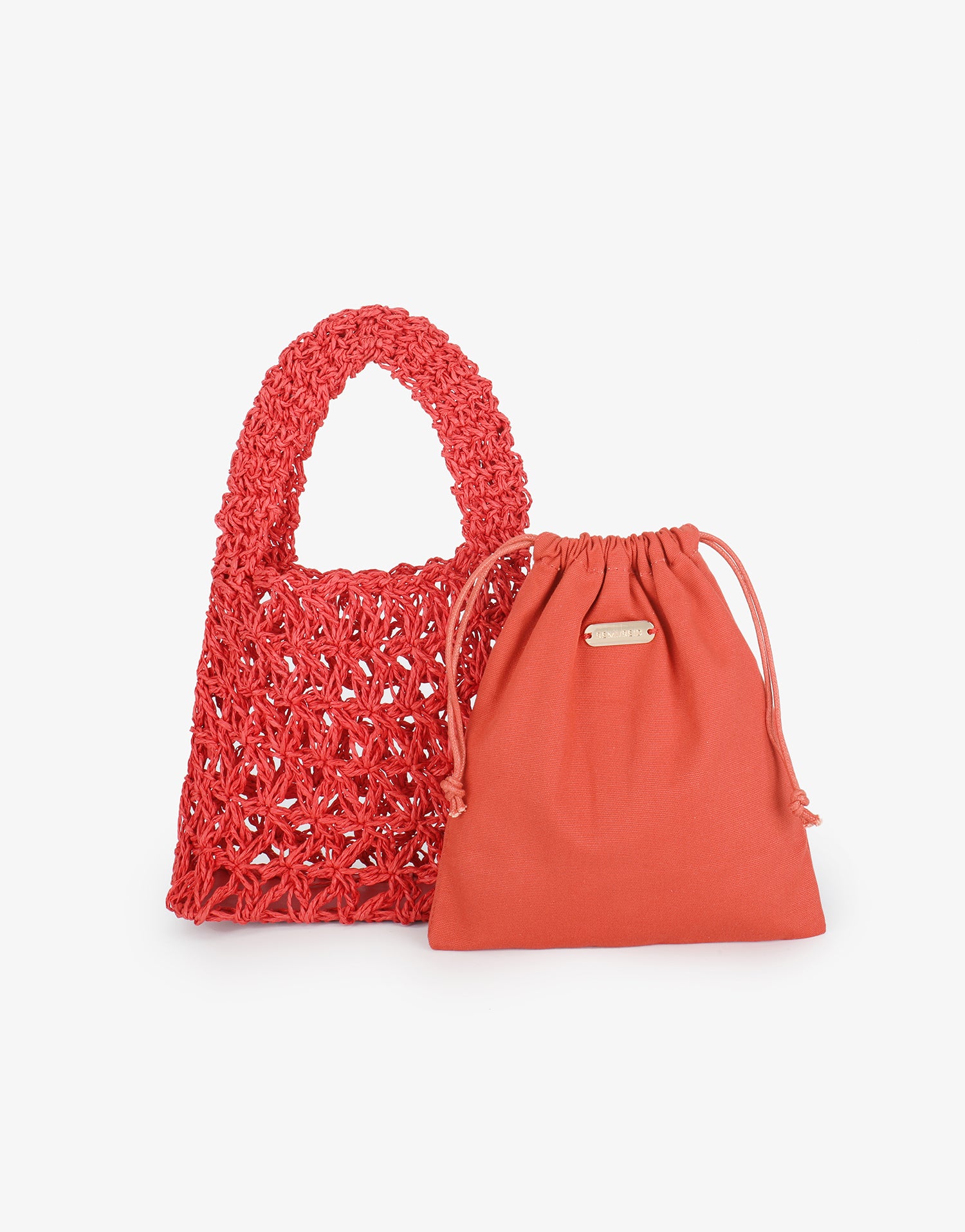 Side-by-side shot of red Nigella  crocheted macramé tote and its coordinating removable drawstring inner bag by Remi and Reid.