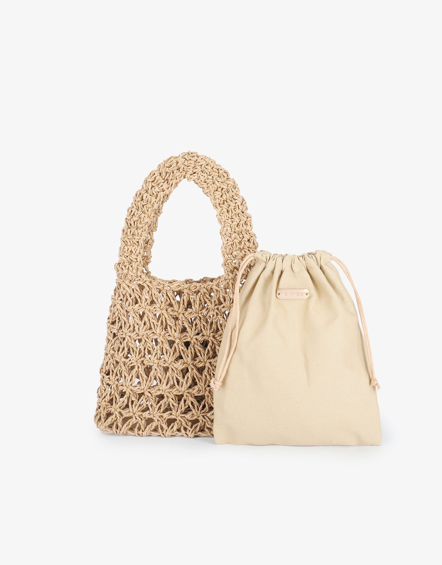 Inner drawstring pouch and crocheted open weave exterior in tan variation by Remi and Reid.