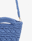 Close-up of the blue Noemi mini tote by Remi and Reid focusing on the gold metal clip and the thick braided blue strap.