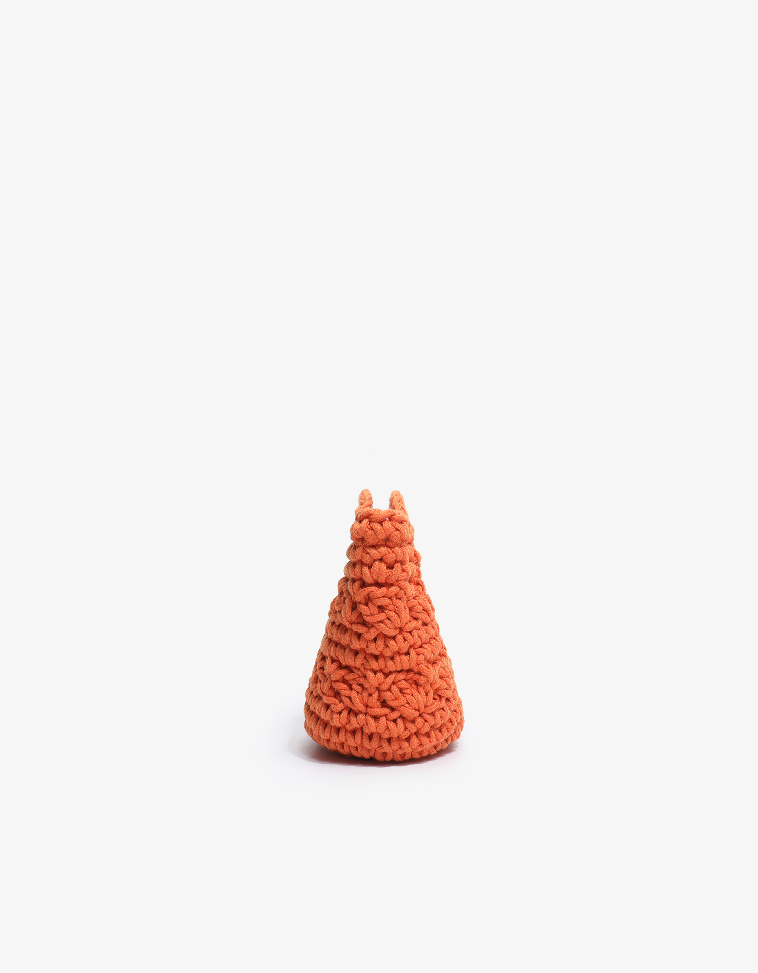 Side profile of the orange Noemi mini tote by Remi and Reid showing the narrow, tapered shape of the crocheted knit.