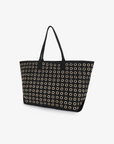Large black canvas Oya Grommet Canvas Tote with rows of gold-tone metal eyelets and dual straps by Remi and Reid.