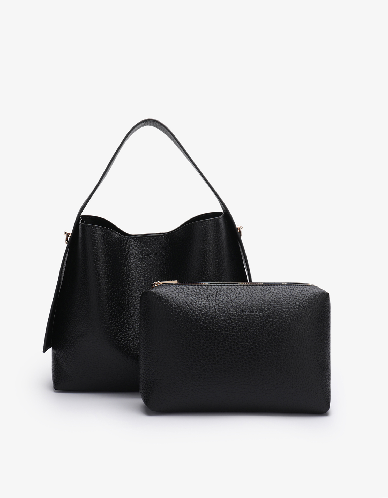 Remi and Reid Paloma Shoulder Bag in textured black vegan leather, featuring a unique wing-like silhouette with a flat top handle wit matching black pouch.