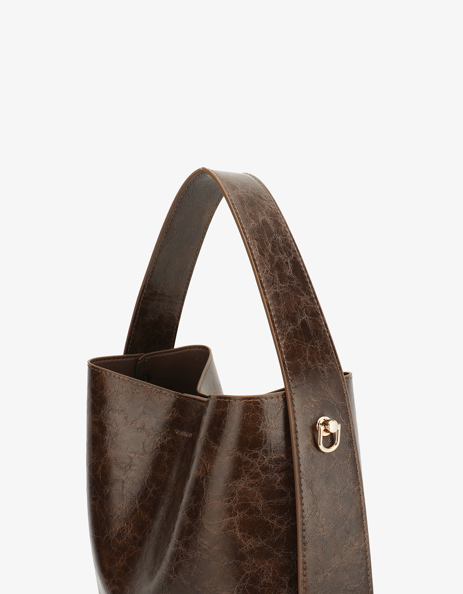 Paloma Waxed vegan leather shoulder bag in brown espresso featuring a wide single strap handle and gold-tone buckle hardware on the side.