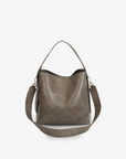 Paloma Waxed vegan leather shoulder bag in gray featuring a wide single strap handle and gold-tone buckle hardware on the side with detachable adjustable strap by Remi and Reid.