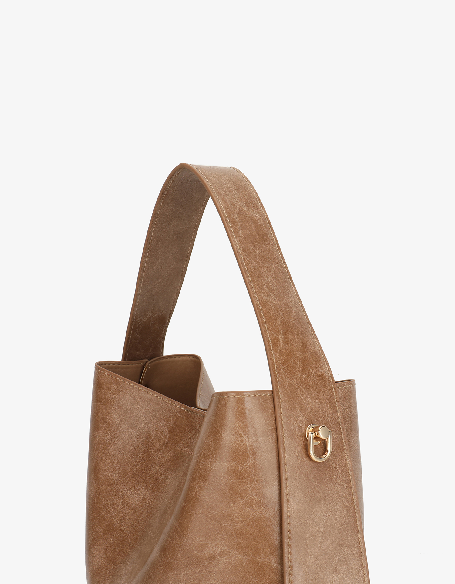 Waxed vegan leather shoulder bag in mauve brown featuring a wide single strap and gold-tone buckle hardware with adjustable shoulder strap by Remi and Reid.