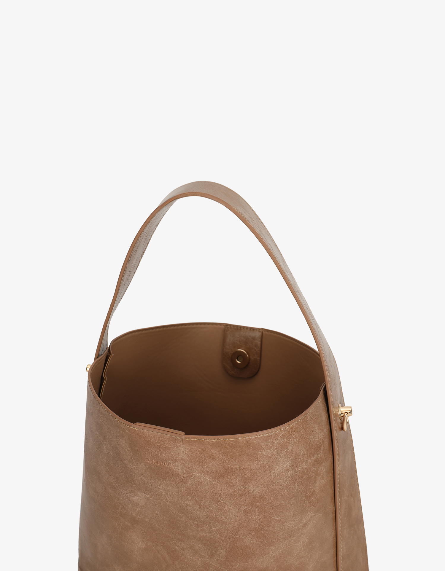 Interior of Paloma waxed vegan leather shoulder bag in mauve brown featuring a wide single strap and gold-tone buckle hardware with magnetic snap closure by Remi and Reid.