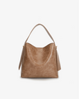 A mauve brown shoulder waxed mauve handbag with minimalist design and a long strap by Remi and Reid.