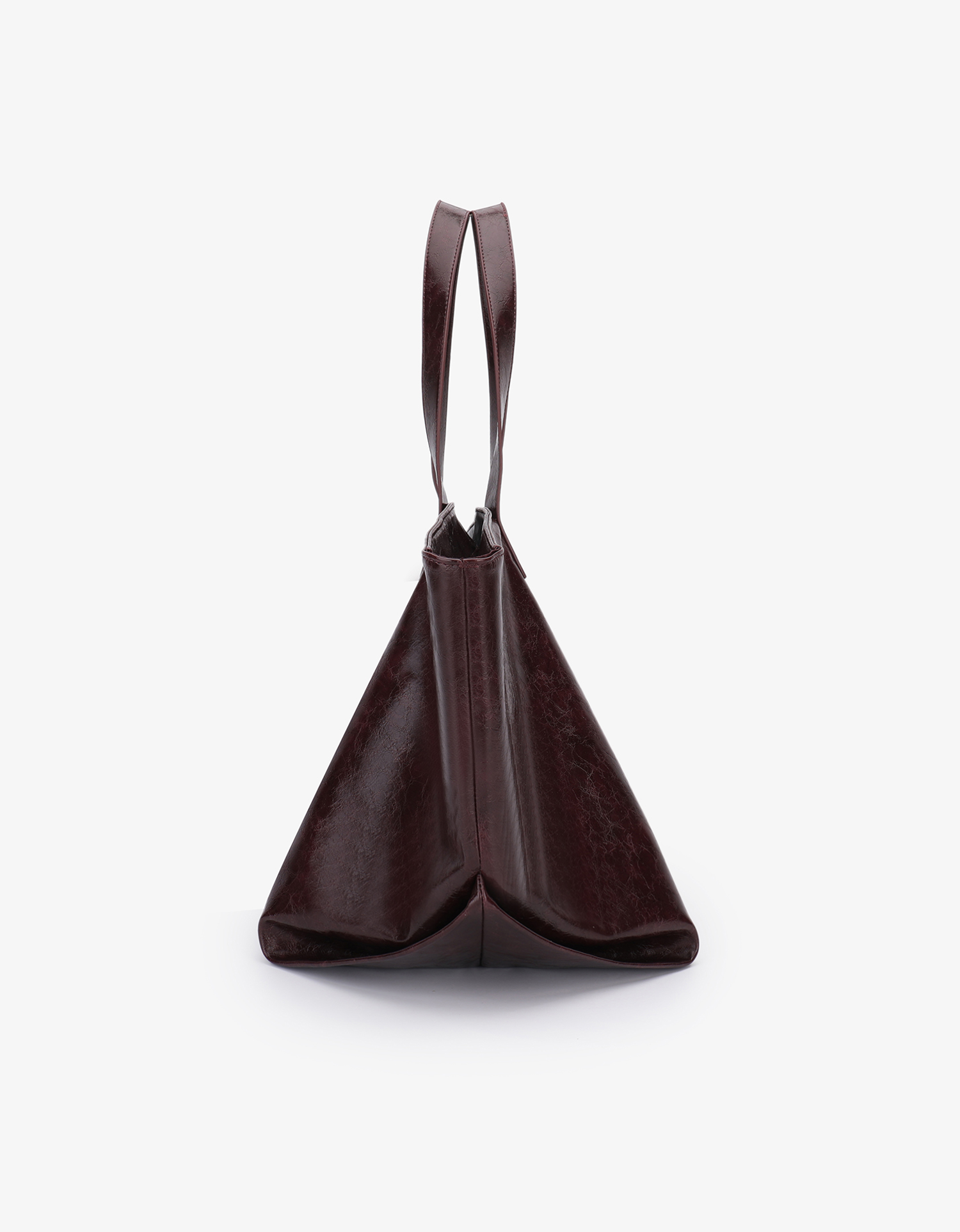 Extra Large Plaisir Tote by Remi and Reid in a deep oxblood red waxed vegan leather with a high-shine, crinkled texture.