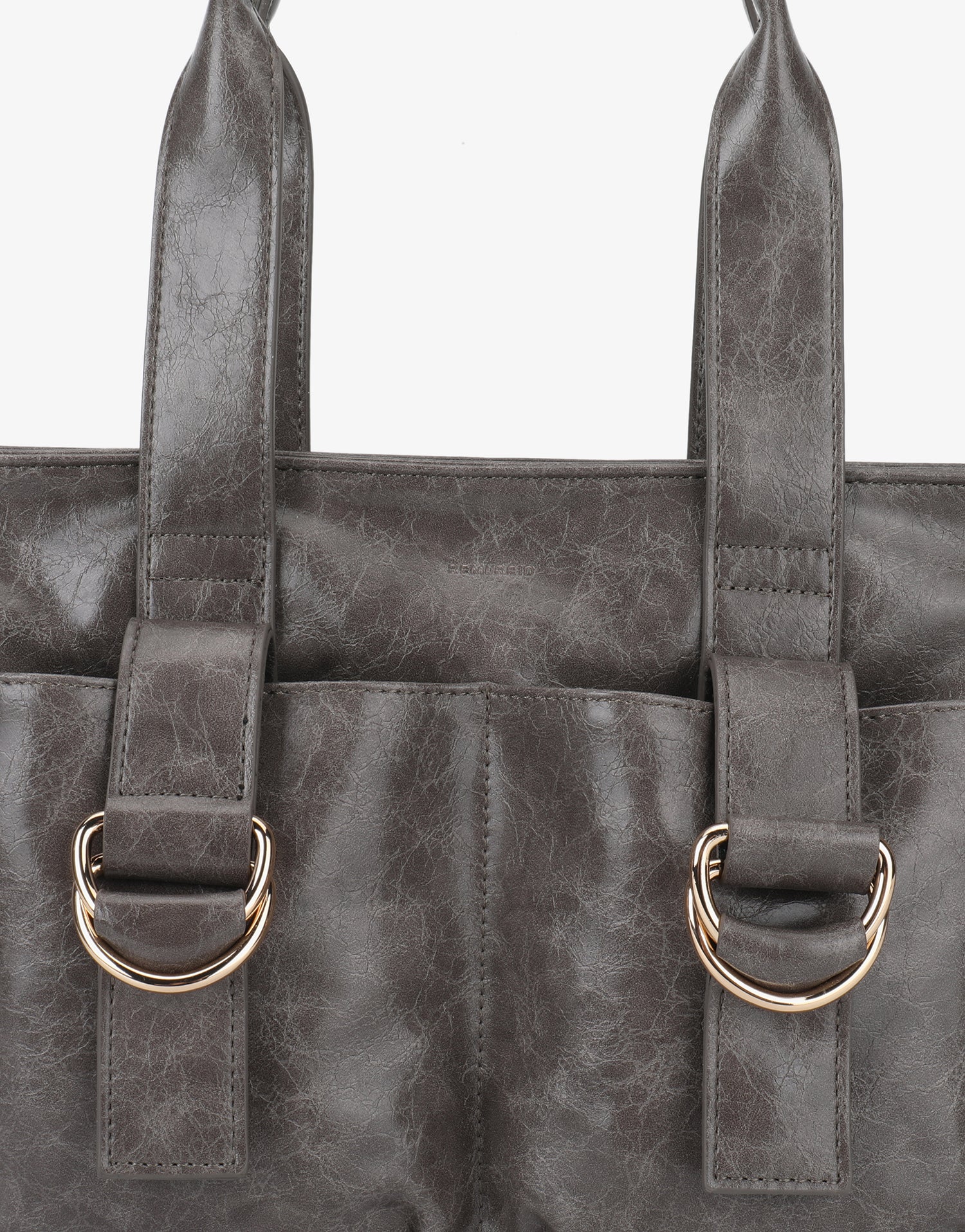 Close-up of a gray cargo bag with gold d-ring handles_Remi and Reid