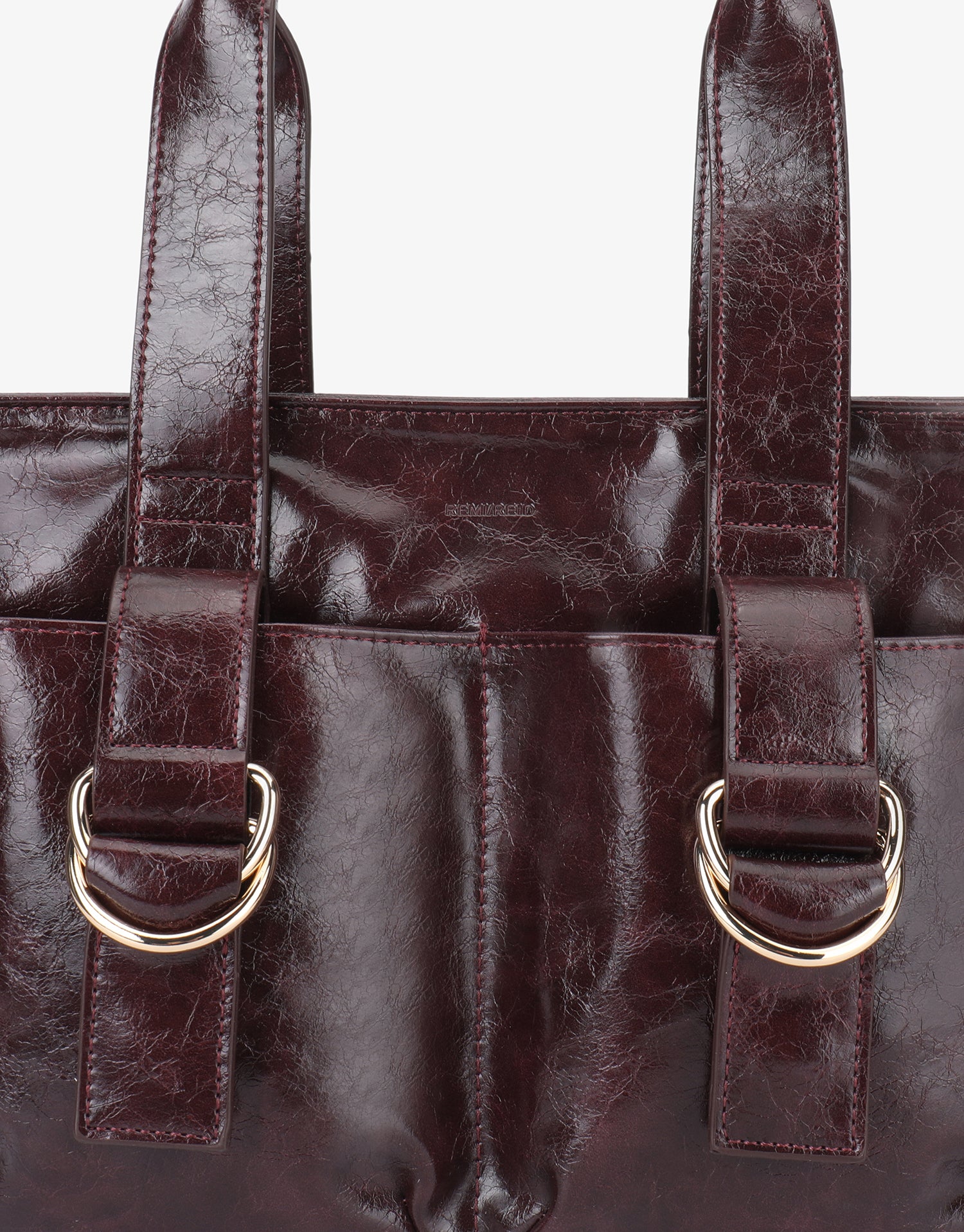 Close-up of brown tote handbag with gold d-buckles design_Remi and Reid